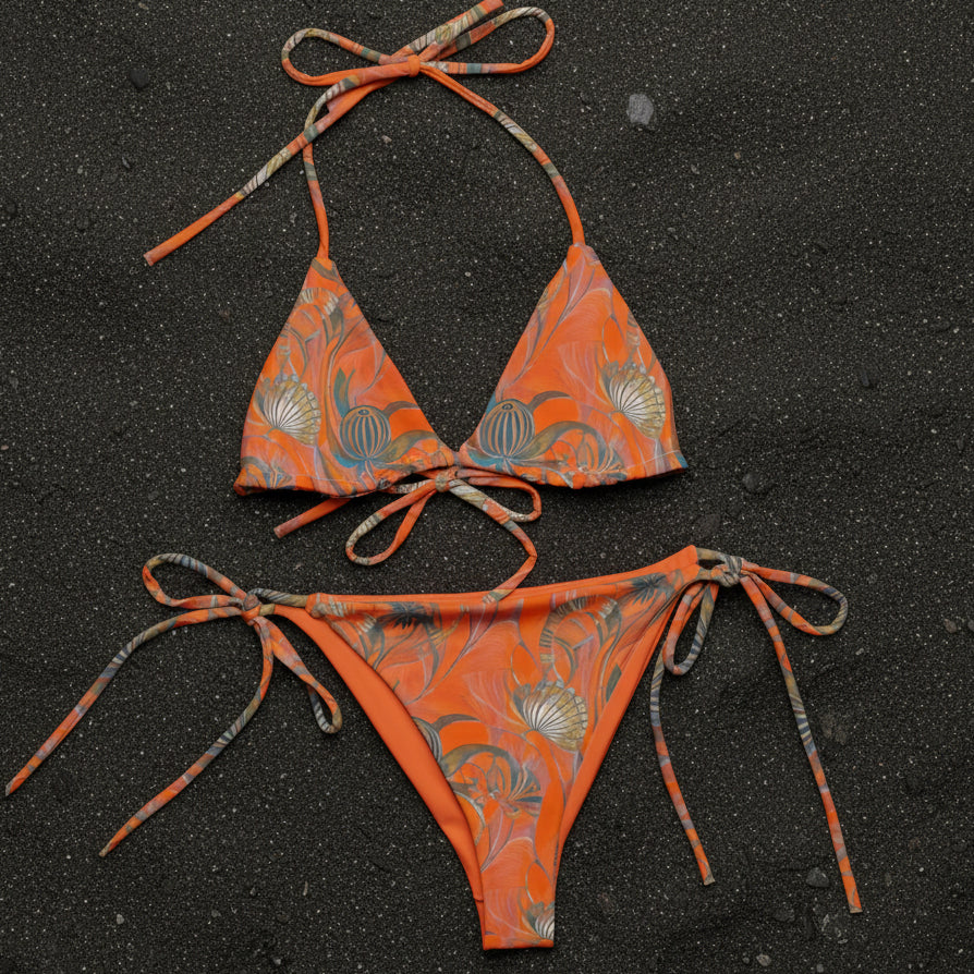 orange shell string bikini on black sand 